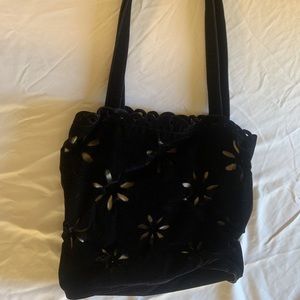 Black velvet purse with gray silk liner with floral cut out.